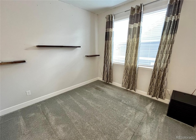 empty room with carpet floors and baseboards