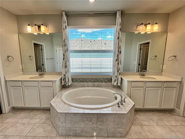 bathroom featuring a bath, two vanities, and a sink