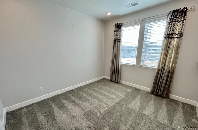 carpeted empty room with baseboards and visible vents