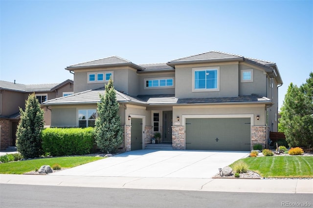 350 Andromeda Ln, Castle Rock, CO 80108 - prairie-style home featuring stucco siding, concrete driveway, a garage, and stone siding
