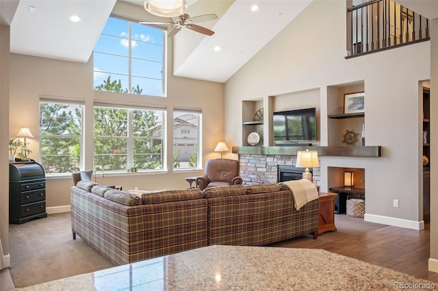 350 Andromeda Ln, Castle Rock, CO 80108 - living room with a ceiling fan, a high ceiling, a fireplace, built in shelves, and recessed lighting