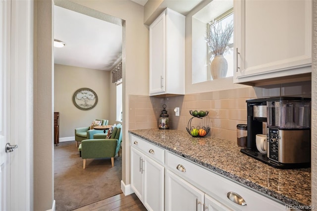 350 Andromeda Ln, Castle Rock, CO 80108 - kitchen featuring white cabinetry, stone countertops, and backsplash