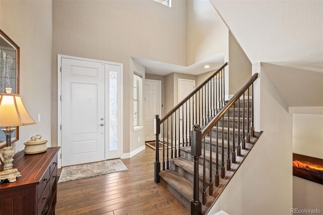 350 Andromeda Ln, Castle Rock, CO 80108 - entryway featuring wood-type flooring, stairway, and a towering ceiling