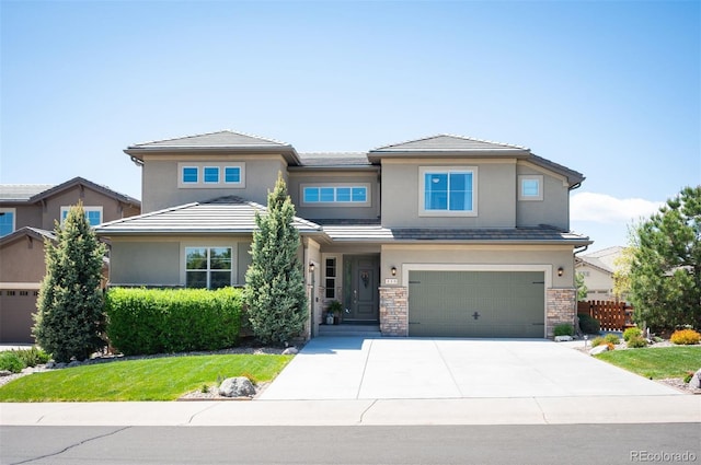 350 Andromeda Ln, Castle Rock, CO 80108 - prairie-style house with stucco siding, concrete driveway, a garage, and a tile roof