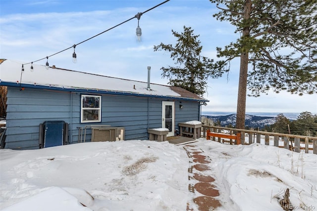 8537 S Doubleheader Hwy, Morrison, CO 80465 - snow covered rear of property featuring a deck with mountain view