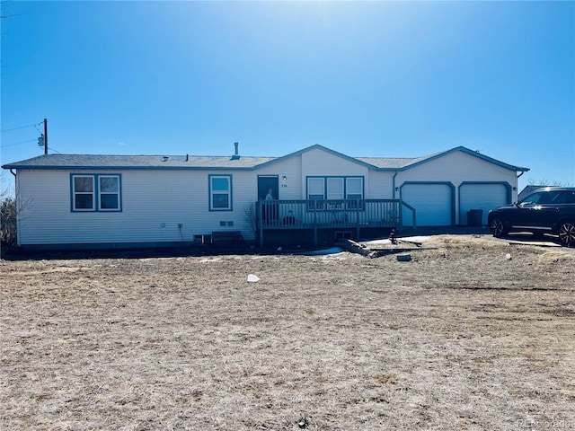 554 E Pleasant Ave, Byers, CO 80103 - manufactured / mobile home with an attached garage and a wooden deck