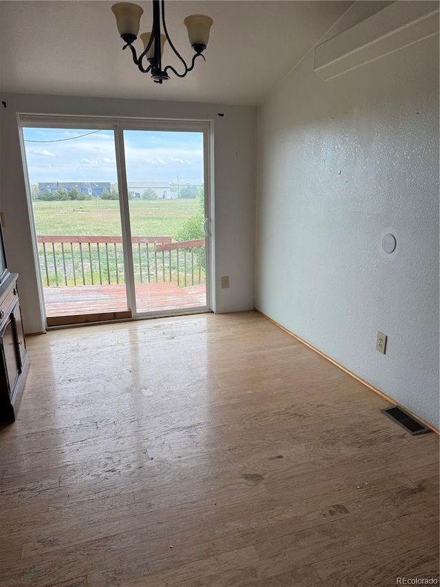 554 E Pleasant Ave, Byers, CO 80103 - unfurnished dining area featuring light wood-style flooring, plenty of natural light, a textured wall, and a chandelier