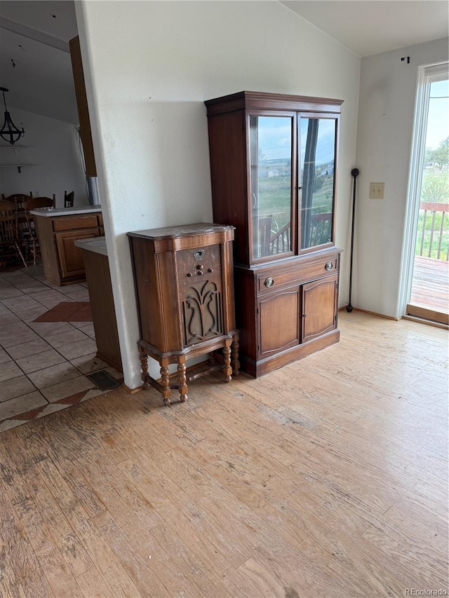 554 E Pleasant Ave, Byers, CO 80103 - living room featuring lofted ceiling, light wood-style flooring, and bar