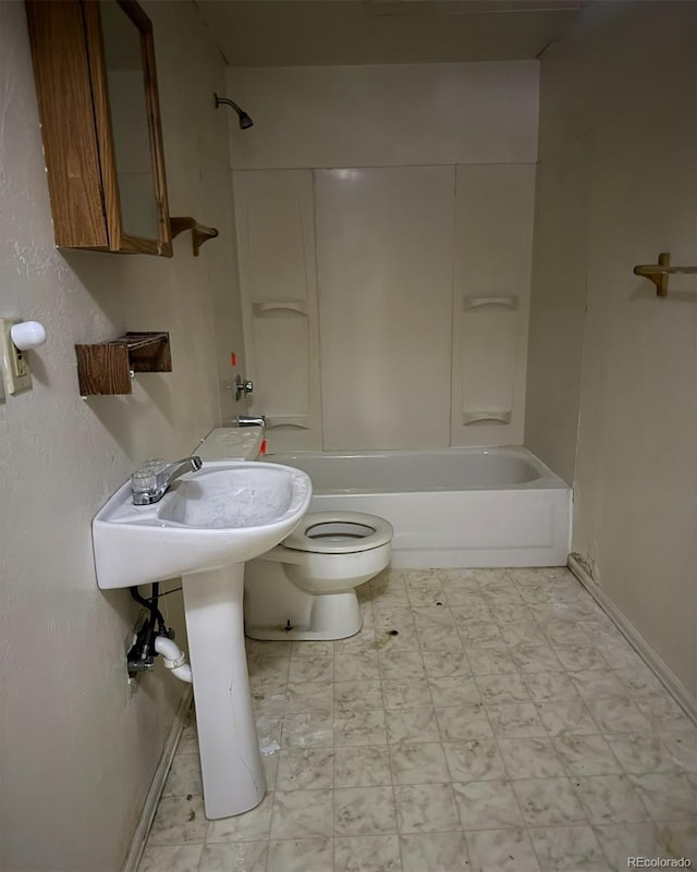 554 E Pleasant Ave, Byers, CO 80103 - full bathroom with toilet, shower / tub combination, baseboards, and a sink