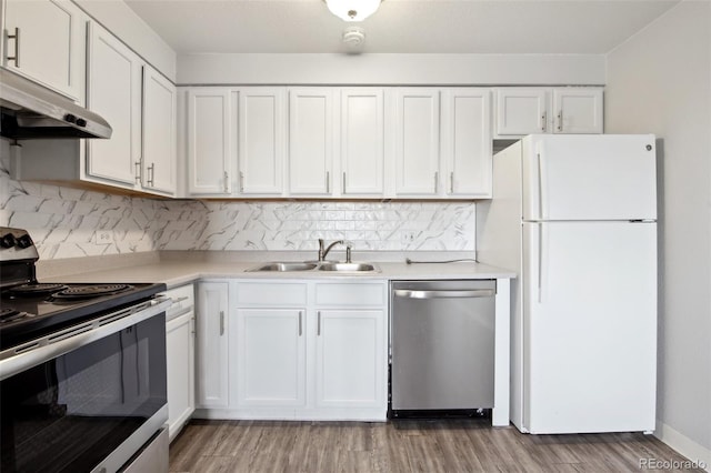 kitchen featuring appliances with stainless steel finishes, white cabinets, and sink