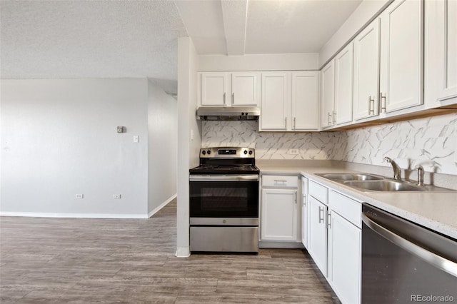 kitchen featuring appliances with stainless steel finishes, a textured ceiling, white cabinets, backsplash, and sink