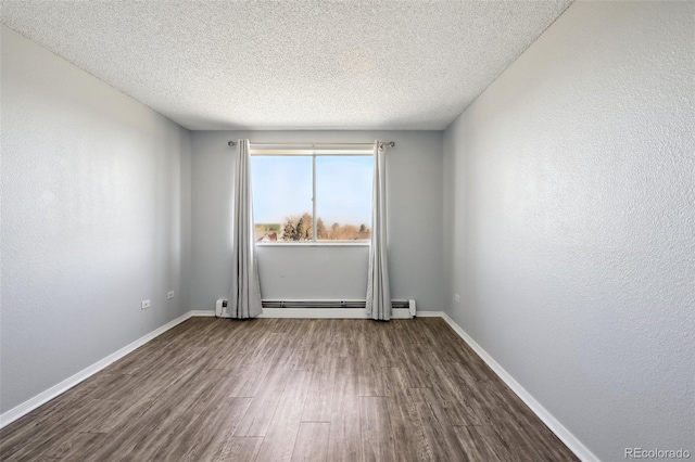 unfurnished room featuring a textured ceiling, a baseboard radiator, and hardwood / wood-style flooring