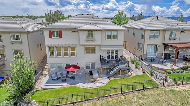 rear view of house featuring a yard and a patio