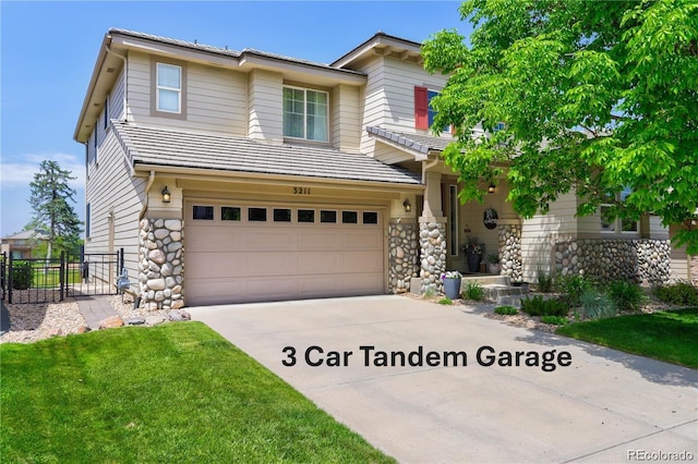 view of front of home with a front yard and a garage