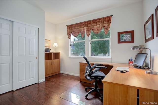 home office with dark hardwood / wood-style flooring