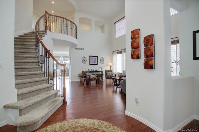 entryway featuring a high ceiling and dark hardwood / wood-style floors