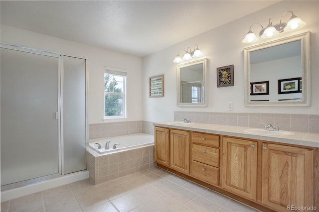 bathroom featuring tile patterned flooring, vanity, and shower with separate bathtub