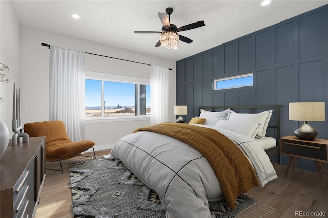 bedroom featuring light hardwood / wood-style flooring and ceiling fan