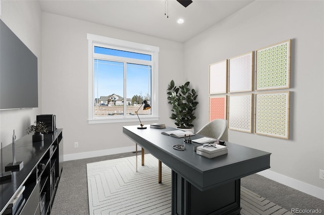 office space featuring ceiling fan and dark colored carpet