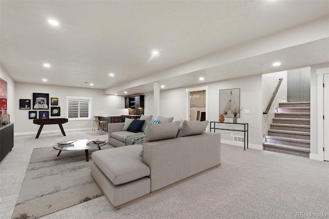 carpeted living room featuring a textured ceiling