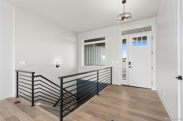 entryway featuring a notable chandelier and light hardwood / wood-style floors