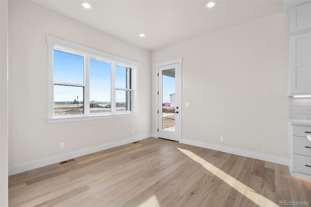 spare room with light wood-type flooring