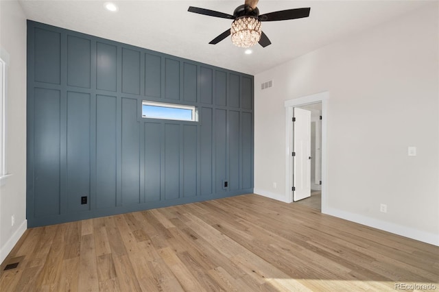 unfurnished bedroom with ceiling fan and light wood-type flooring