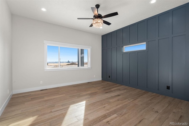 empty room featuring light hardwood / wood-style flooring and ceiling fan