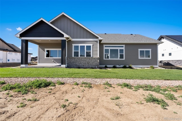 1369 Burt Ave, Berthoud, CO 80513 - rear view of property with board and batten siding, a yard, and stone siding