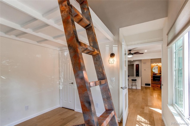 hallway with light wood-style flooring and baseboards