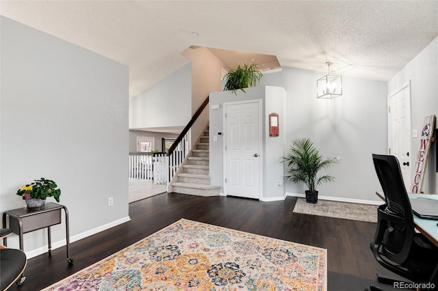 office featuring a textured ceiling, wood finished floors, baseboards, lofted ceiling, and an inviting chandelier