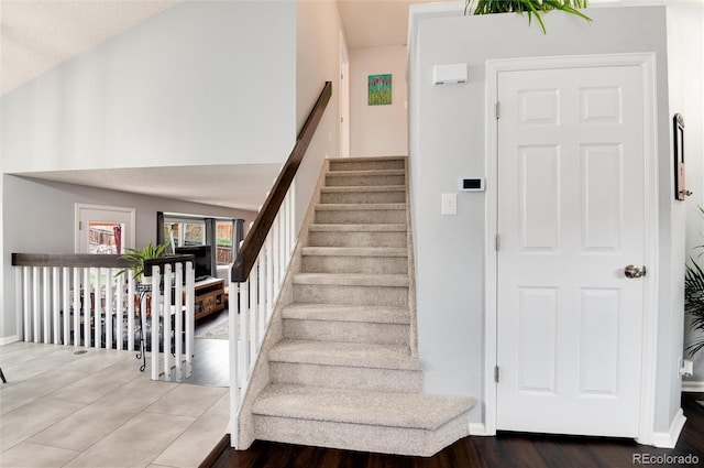 stairs featuring baseboards and wood finished floors