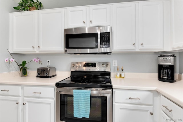 kitchen with light countertops, white cabinetry, and stainless steel appliances