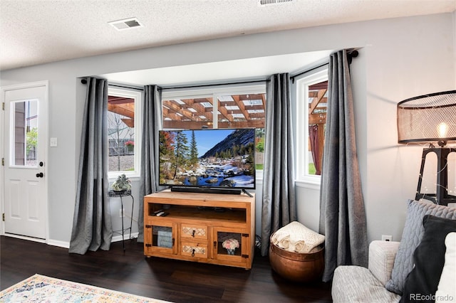 interior space with visible vents, dark wood-style flooring, and baseboards