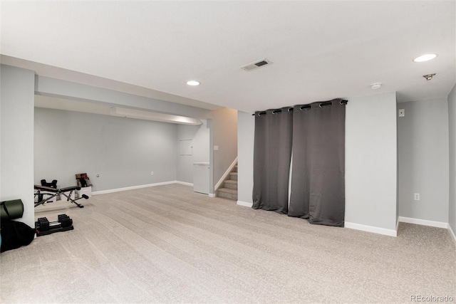 finished below grade area with carpet floors, recessed lighting, visible vents, and stairs