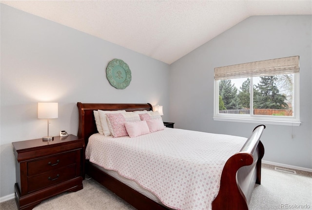 bedroom featuring light colored carpet, baseboards, visible vents, and vaulted ceiling