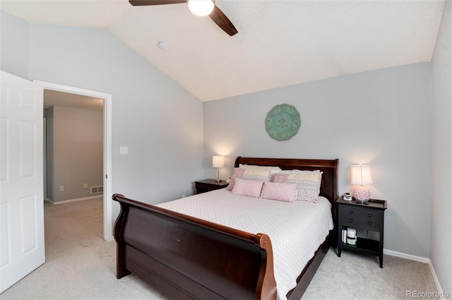 bedroom featuring light colored carpet, a ceiling fan, baseboards, and vaulted ceiling