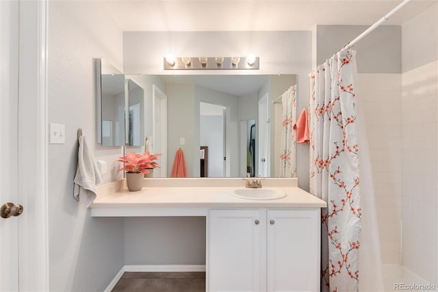 full bath with vanity and tiled shower