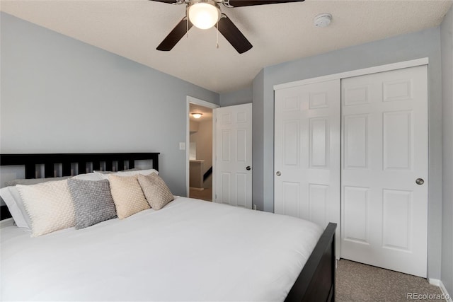 carpeted bedroom featuring a closet and ceiling fan