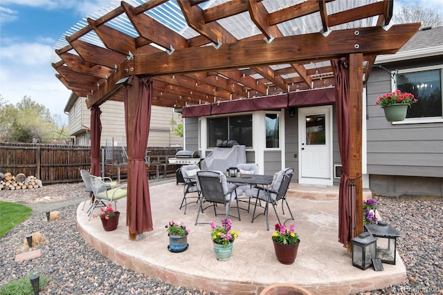 view of patio / terrace with fence, a pergola, and outdoor dining area