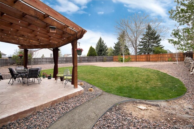 view of yard with a fenced backyard, a pergola, and a patio area