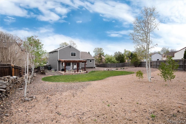 back of house featuring a fenced backyard and a patio area