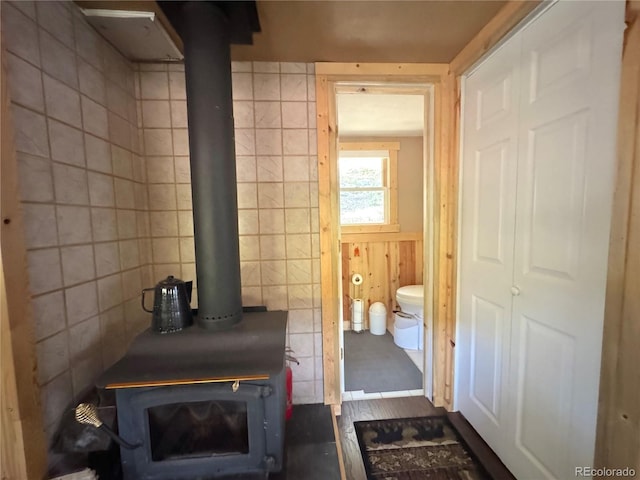 582 Pactolus Lake Rd, Black Hawk, CO 80422 - bathroom with a wood stove and tile walls