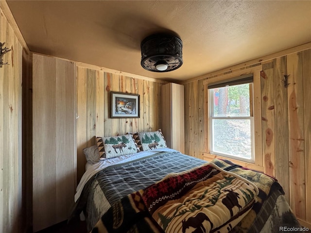 582 Pactolus Lake Rd, Black Hawk, CO 80422 - bedroom with wood walls and a textured ceiling