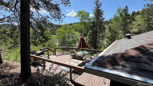 582 Pactolus Lake Rd, Black Hawk, CO 80422 - wooden deck featuring a view of trees and outdoor dining area