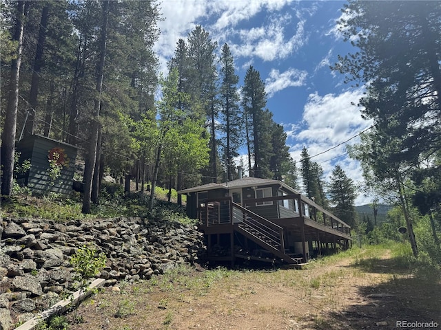 582 Pactolus Lake Rd, Black Hawk, CO 80422 - back of house with stairs, a deck, and a sunroom