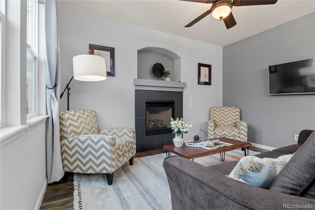 living room with dark hardwood / wood-style floors and ceiling fan