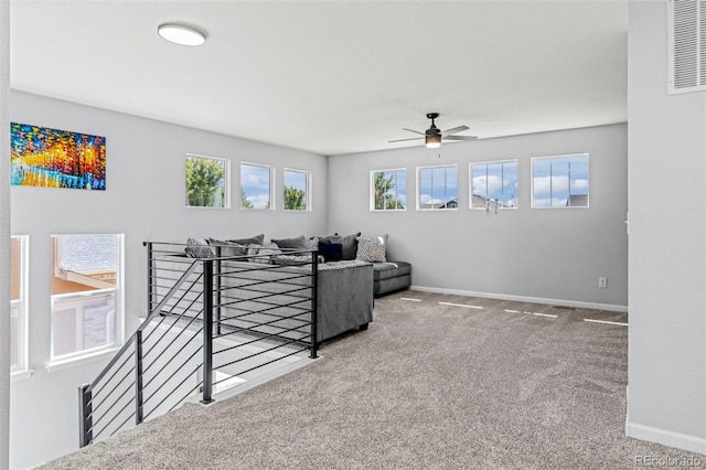 carpeted living room with ceiling fan