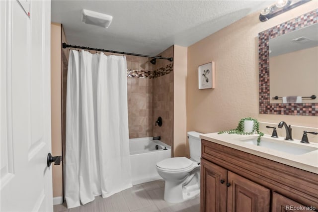 full bathroom with shower / bath combo, vanity, a textured ceiling, tile patterned flooring, and toilet