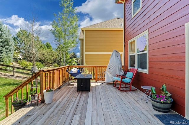 wooden deck featuring a fire pit